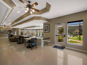 A spacious, modern kitchen with a central island, large windows, and a view of the outside. - Sleep Inn Savannah Midtown (Savannah)