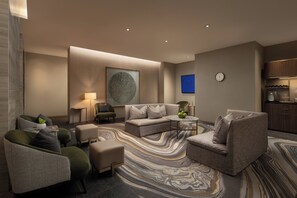 Relax in this stylish living room with a sofa, armchairs, and a coffee table.