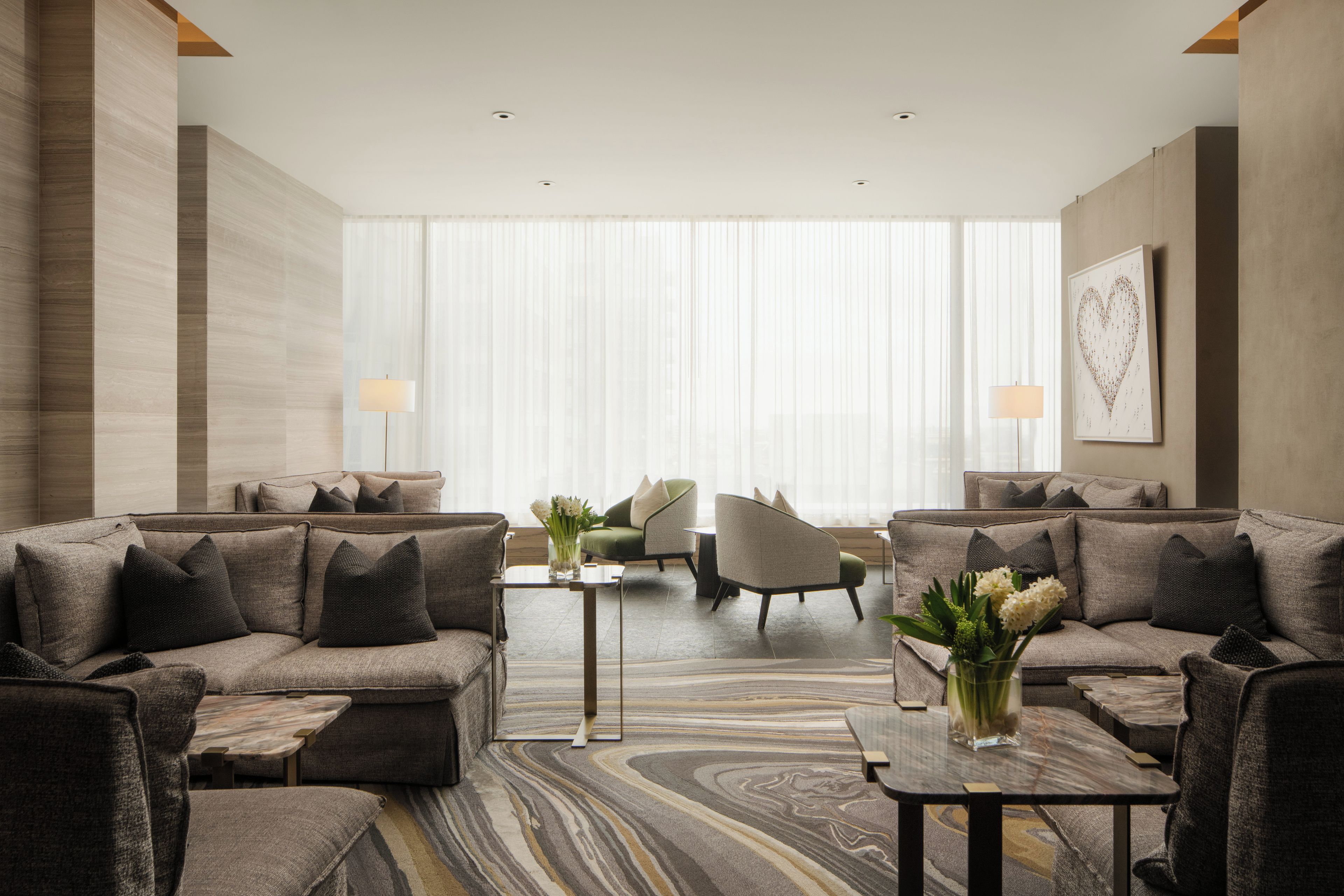 A modern living room with a sectional sofa, a small table, and a decorative vase.