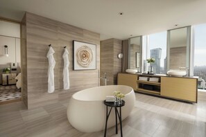 A modern bathroom with a freestanding bathtub, a large mirror, and a view of the cityscape. - Four Seasons Hotel Toronto (Toronto)