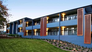 A modern multi-story building with balconies, large windows, and a landscaped garden area. - The Sebel Bowral Heritage Park (Bowral)