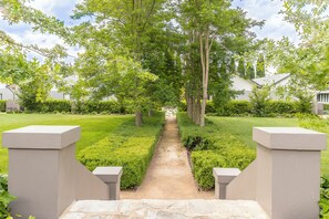 Stroll through the serene garden to the entrance of this tranquil residence.