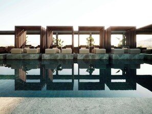A modern pool area with tiered seating and large windows.