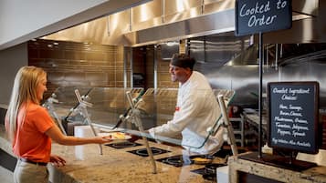 A buffet counter with a sign indicating food is cooked to order.