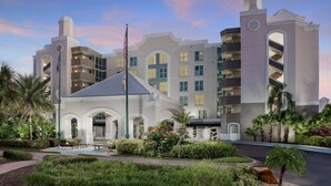 A modern hotel with multiple balconies, a central courtyard, and a mix of architectural styles.