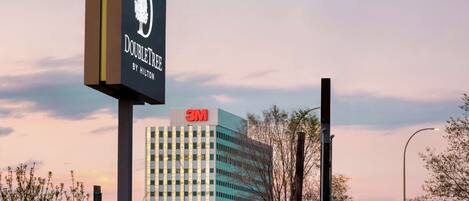 A hotel sign with a tree logo and the name "DOUBLETREE BY HILTON".