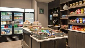A self-service food area with refrigerated drinks, snacks, and prepared food items. - DoubleTree by Hilton St. Paul East (St. Paul)
