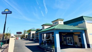 A Days Inn with a blue and white exterior, a covered entrance, and a parking lot.