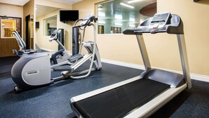 A gym with a treadmill, elliptical, and stationary bike. - Baymont by Wyndham Helena (Helena)