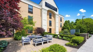 The Crossroads Hotel with outdoor seating and well-maintained landscaping. - The Crossroads Hotel, Newburgh (Newburgh)