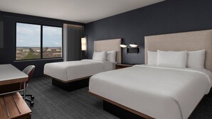 A hotel room with two beds, a desk, and a large window offering a view of the landscape. - Courtyard by Marriott San Diego Miramar (San Diego)