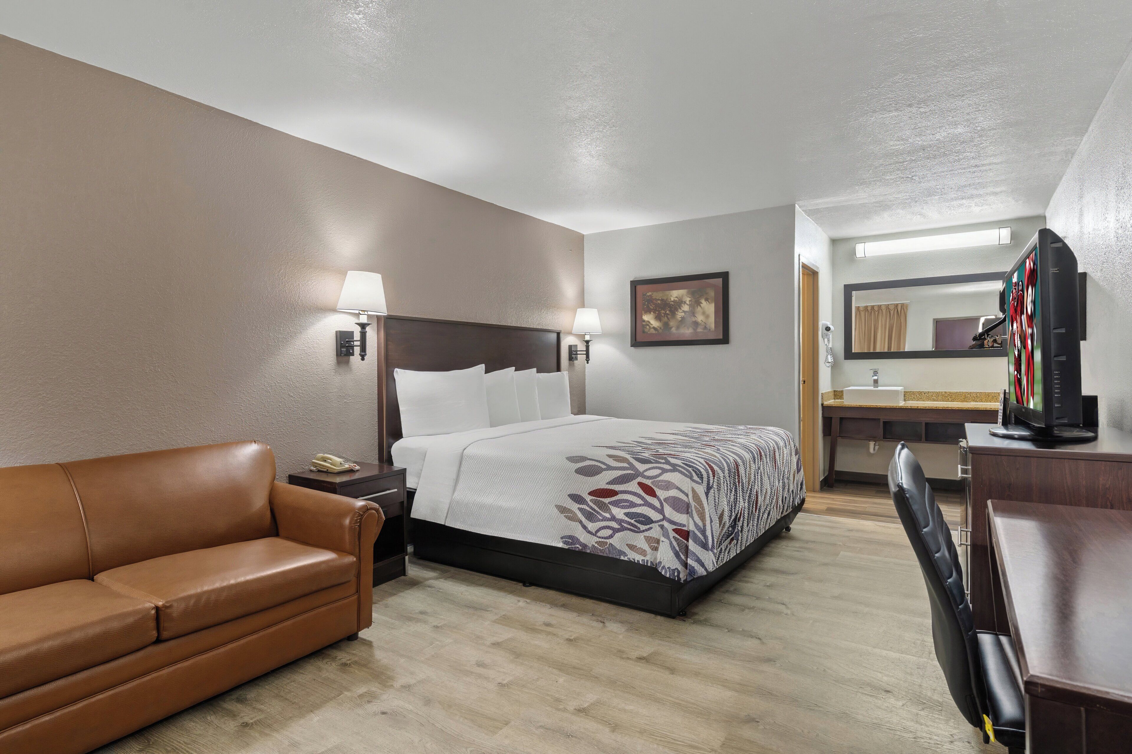 deluxe room, 1 king bed, non smoking | desk, laptop workspace, blackout curtains, iron/ironing board