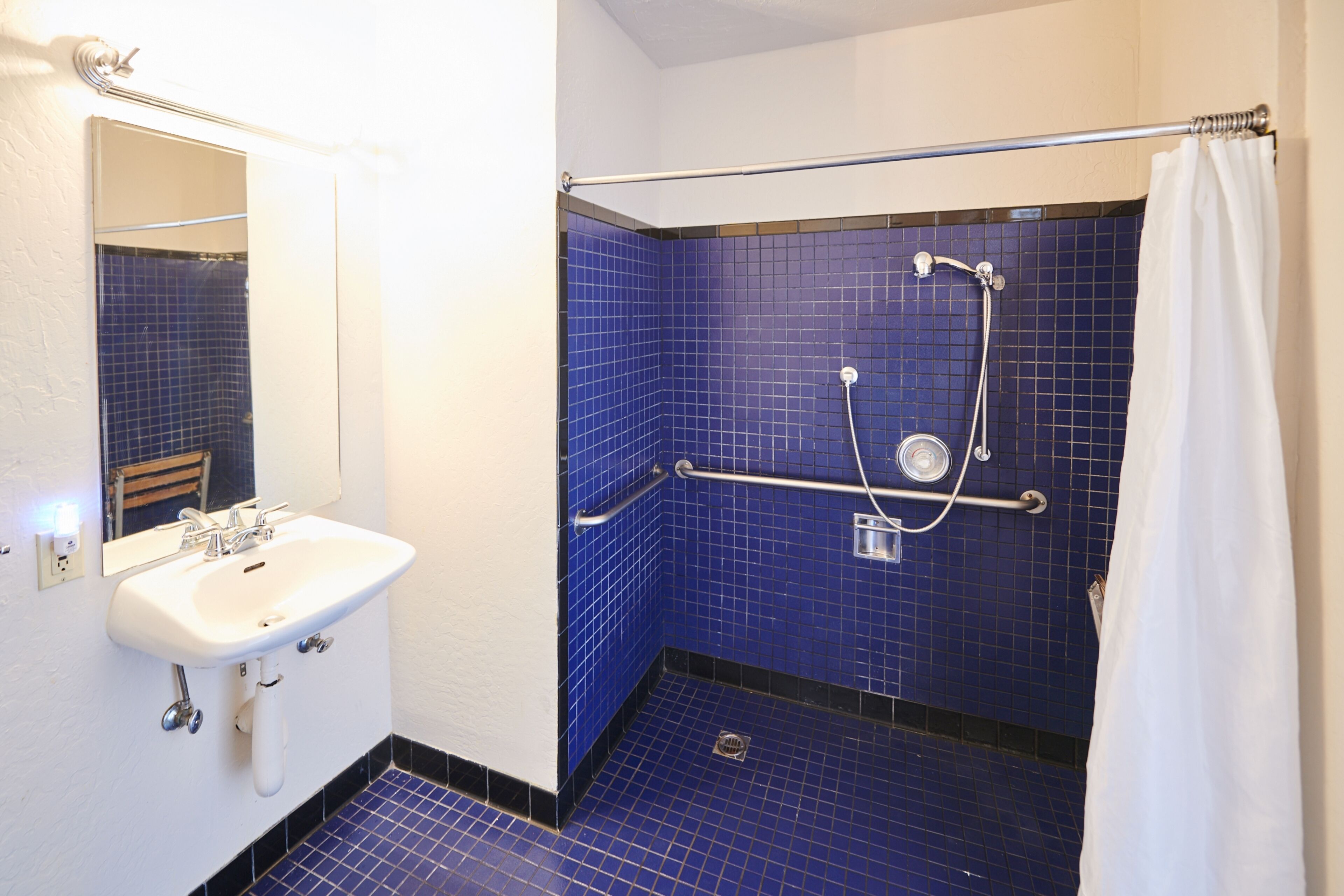 superior room king accessible | bathroom | shower, designer toiletries, hair dryer, bathrobes