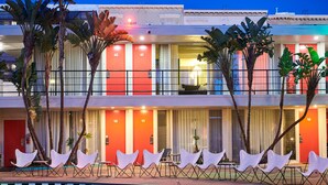 A hotel with a pool, numbered rooms, and lounge chairs. - The Phoenix Hotel (San Francisco)