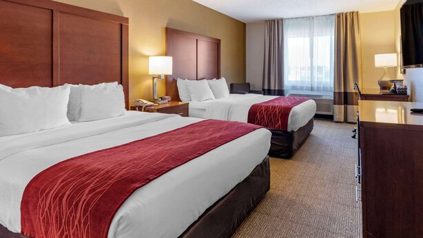 A hotel room with two beds, a desk, a chair, and a window with curtains. - Comfort Inn Great Falls South (Great Falls)