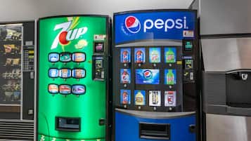 Two beverage vending machines, one for 7UP and one for Pepsi, with various drink options and a recycling symbol.