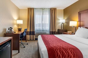 A hotel room with a bed, desk, chair, and a telephone. - Comfort Inn Great Falls South (Great Falls)