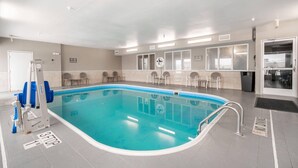 A swimming pool with a 3-step entry, chairs around the pool, and a no diving sign on the wall. - Comfort Inn Great Falls South (Great Falls)