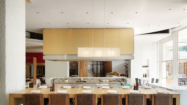 A modern kitchen with a central island, bar stools, and a dining area with a large window. - Grand Hyatt Istanbul (Istanbul)