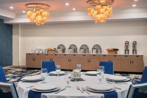 A conference room with a long table set for a meeting, equipped with chairs, plates, glasses, and cutlery. - DoubleTree by Hilton Wilmington, NC (Wilmington)