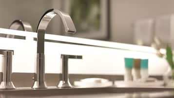 A modern bathroom with a sleek, curved faucet and a countertop.