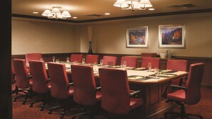 A conference room with a long table, red chairs, and two framed pictures on the wall. - DoubleTree by Hilton Cincinnati Airport (Florence)