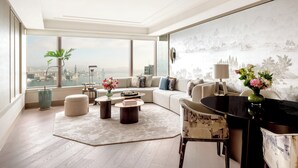 A modern living room with a large window, a sofa set, a coffee table, and a dining table. - Island Shangri-La, Hong Kong (Hong Kong)
