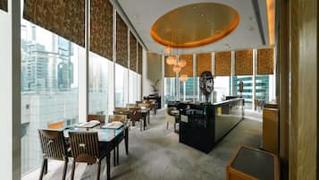 A modern dining area with large windows, a central island, and a city view.