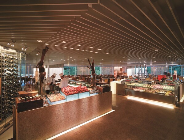 A spacious food court with multiple counters and a variety of food displays. - Island Shangri-La, Hong Kong (Hong Kong)