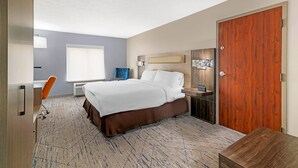 A hotel room with a bed, a desk, a chair, a wooden door, and a window. - Keene Elm City Hotel, an Ascend Collection Hotel (Keene)