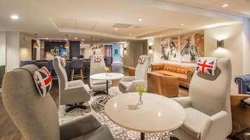 Relax in our stylish lobby, featuring comfortable seating and a vibrant art piece.