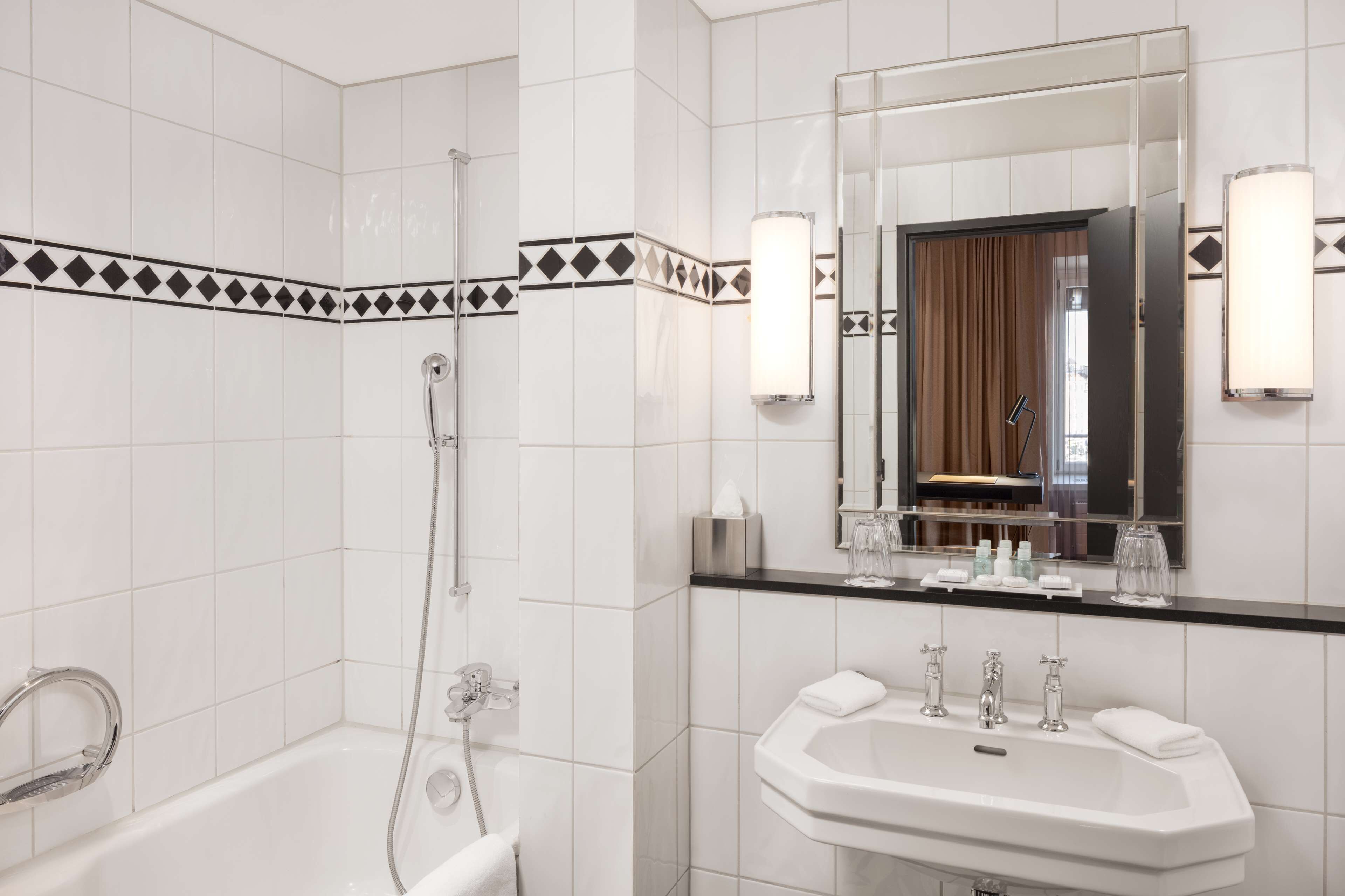 A modern bathroom with a bathtub, a sink, and a shower.