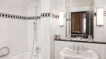 A modern bathroom with a bathtub, a sink, and a shower.