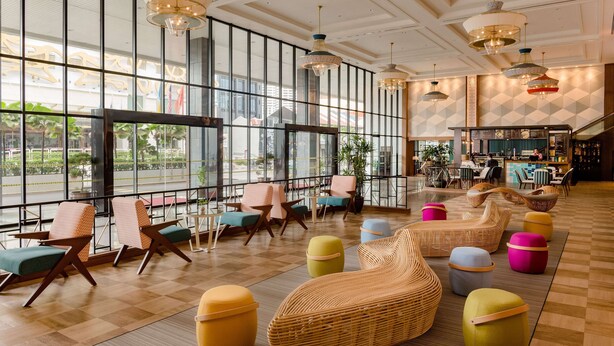 A spacious lobby with large windows, wicker furniture, and a bar area. - JEN Penang Georgetown by Shangri-La (George Town)