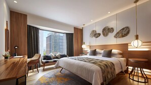 A modern hotel room with a large bed, a desk, a chair, and a view of the cityscape. - JEN Penang Georgetown by Shangri-La (George Town)