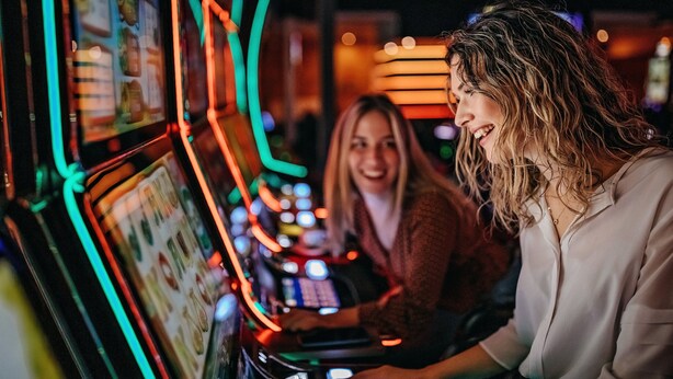 A slot machine with illuminated reels and a control panel.