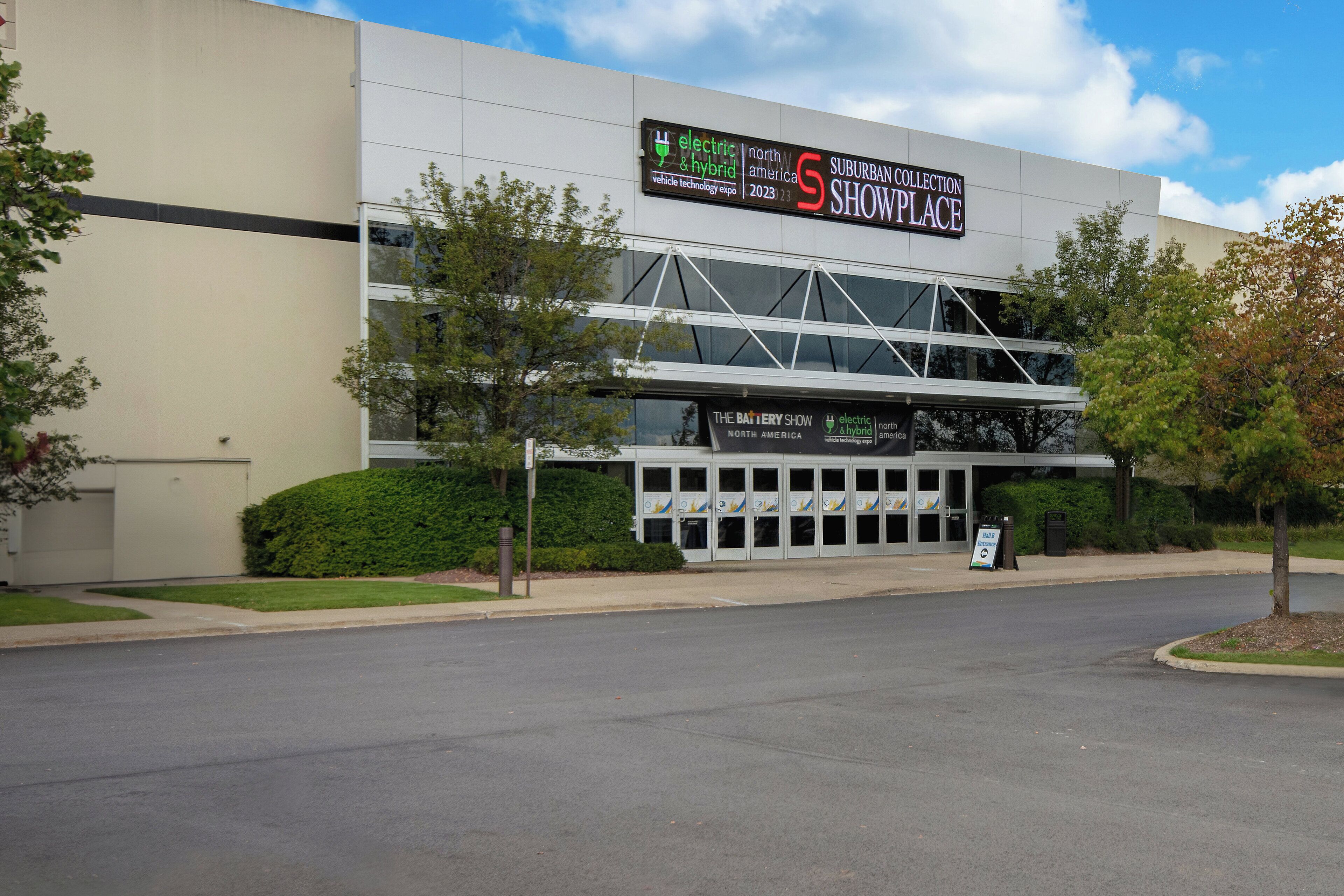 A modern building with a sign for the 'Suburban Collection Showcase' and 'The Battery Show'.