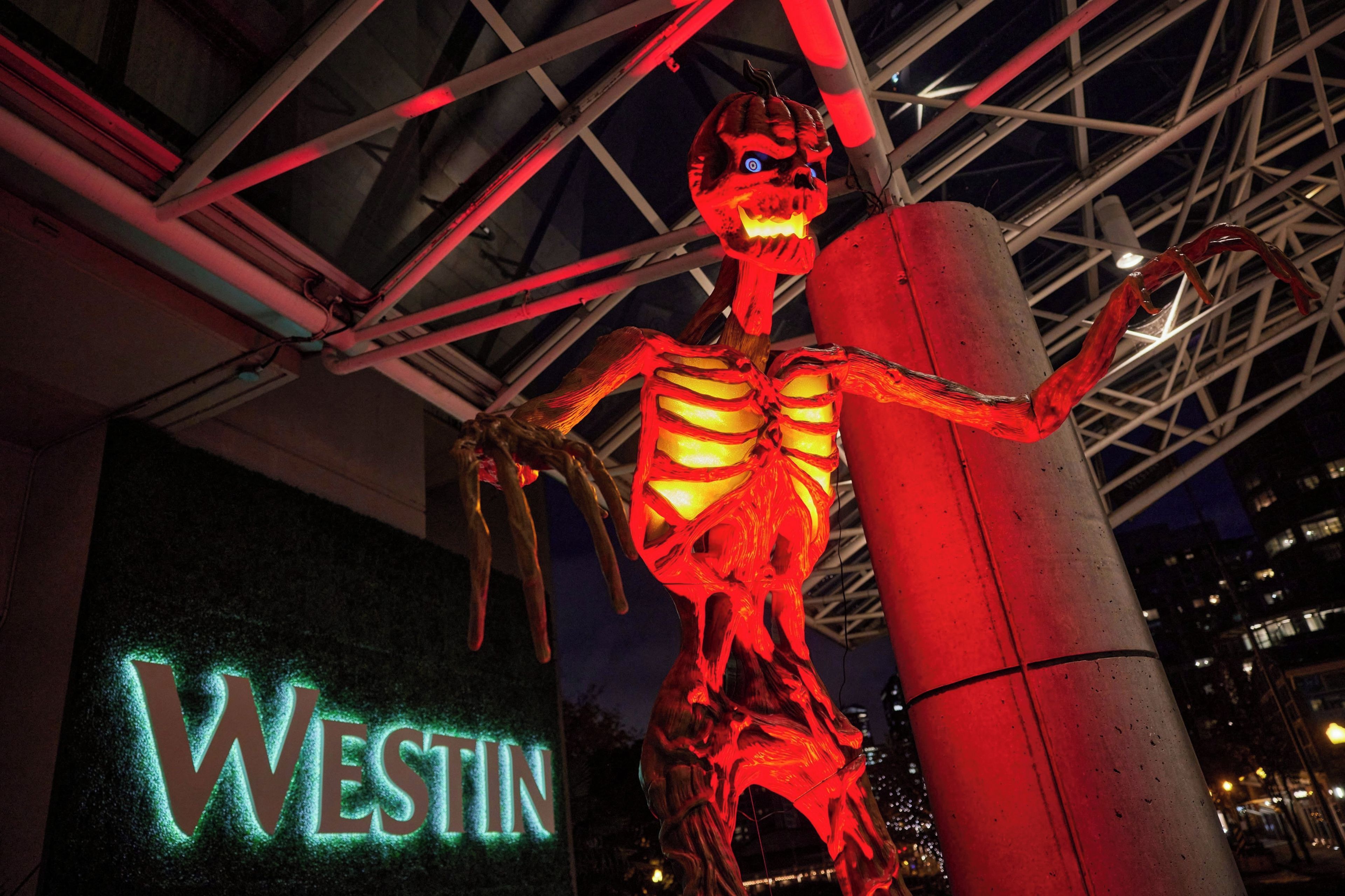 A skeleton figure with glowing red lights, positioned next to a sign that reads 'WESTIN'.