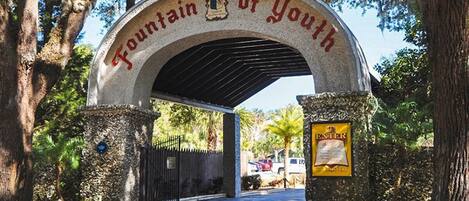 An entrance archway with the inscription "Fountain of Youth" and a signboard to the right.