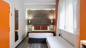A modern hotel room with a large bed, a smaller bed, a nightstand, and a window with sheer curtains.