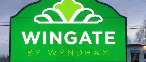 A green sign with the text "WINGATE BY WYNDHAM" and a stylized bird logo.