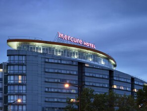 A hotel with a prominent 'Mercure Hotel' sign, multiple floors, and a modern architectural design. - Mercure Paris 19 Philharmonie La Villette (Paris)