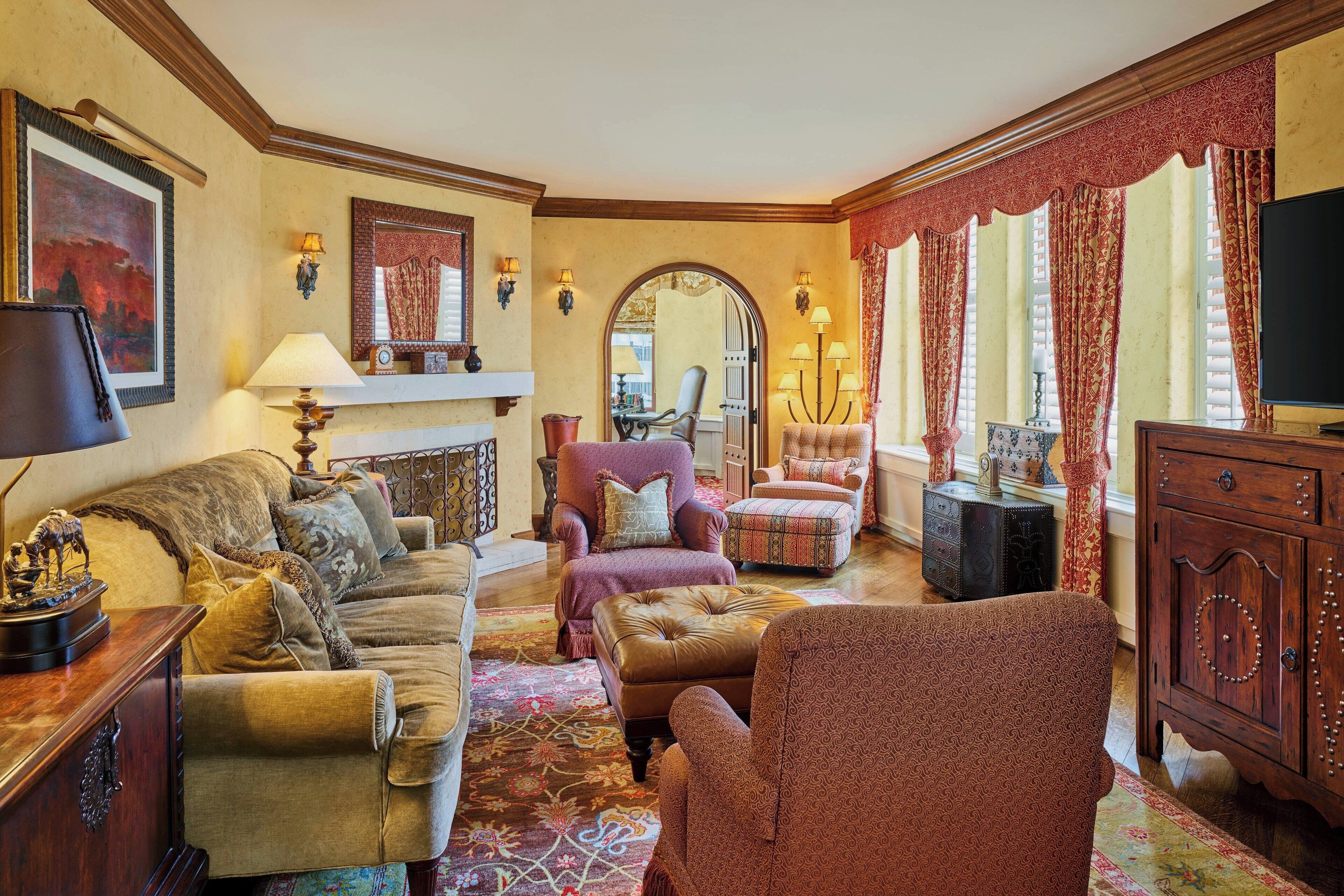 A traditional living room with a fireplace, comfortable seating, and classic decor.