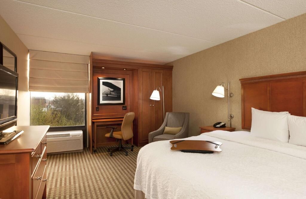 Premium bedding, desk, laptop workspace, blackout drapes