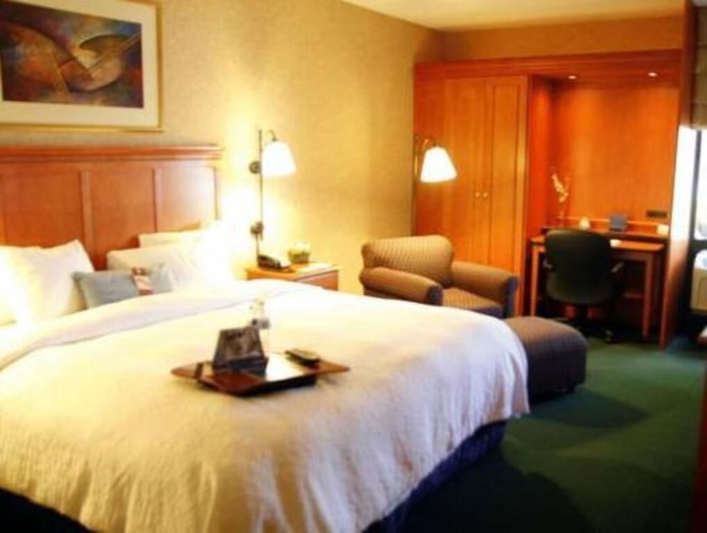 Premium bedding, desk, laptop workspace, blackout drapes