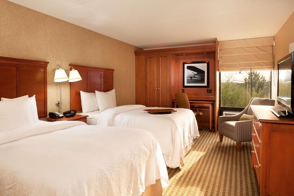 Premium bedding, desk, laptop workspace, blackout drapes