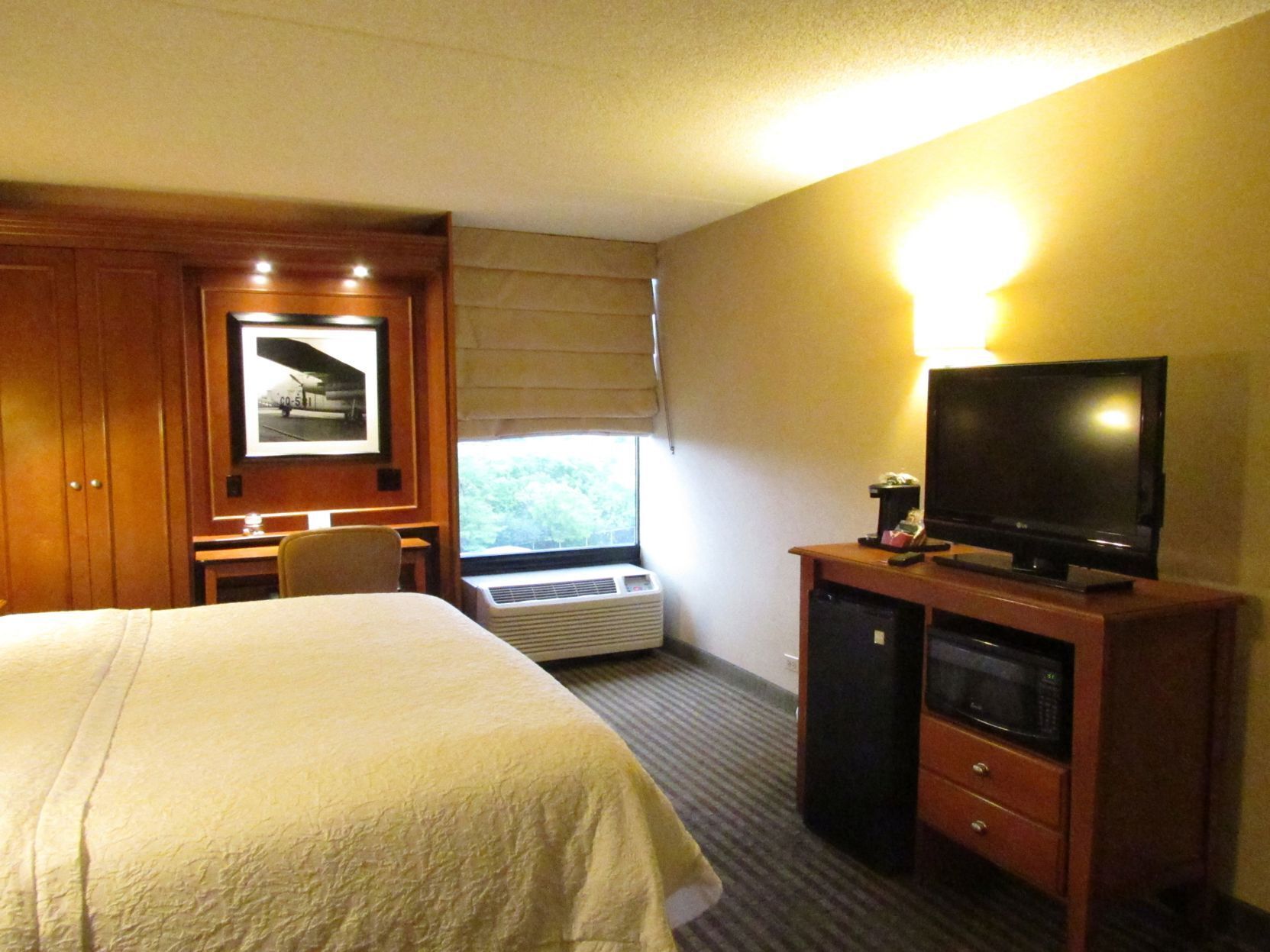 Premium bedding, desk, laptop workspace, blackout drapes