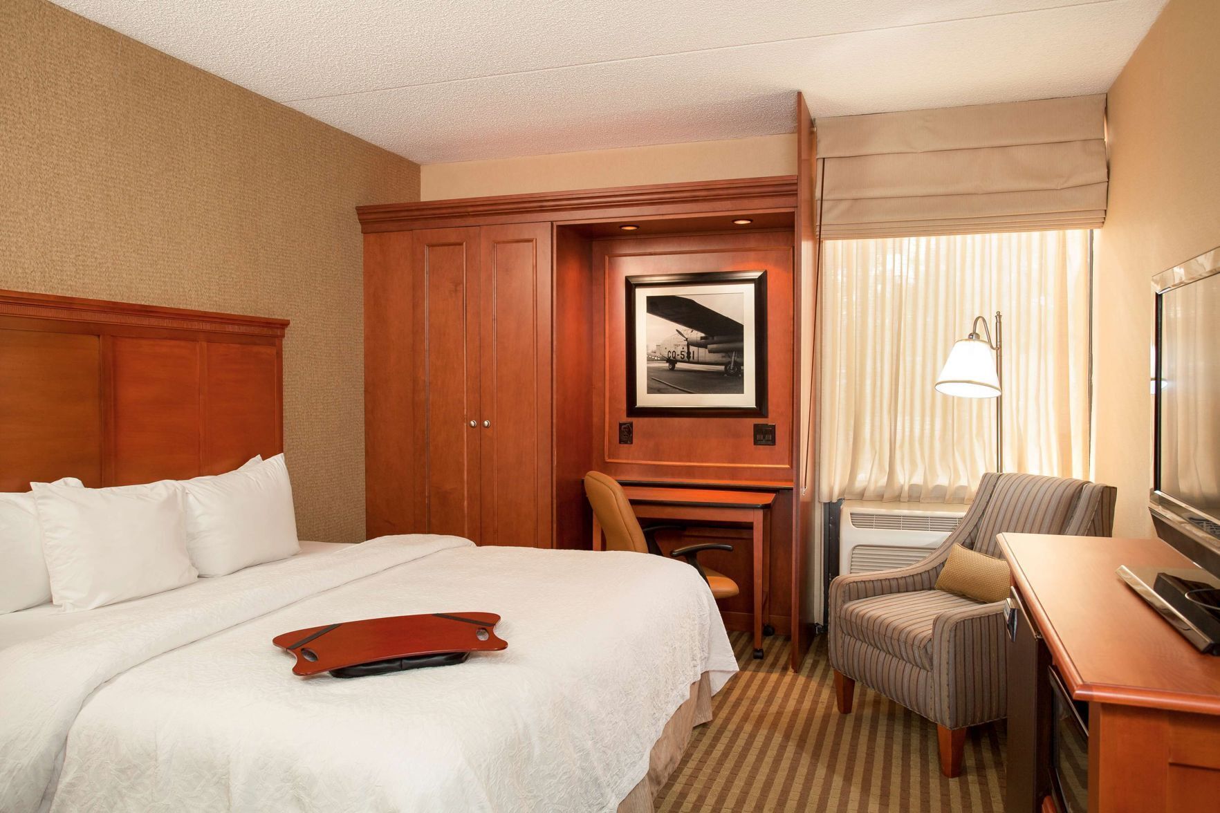 Premium bedding, desk, laptop workspace, blackout drapes