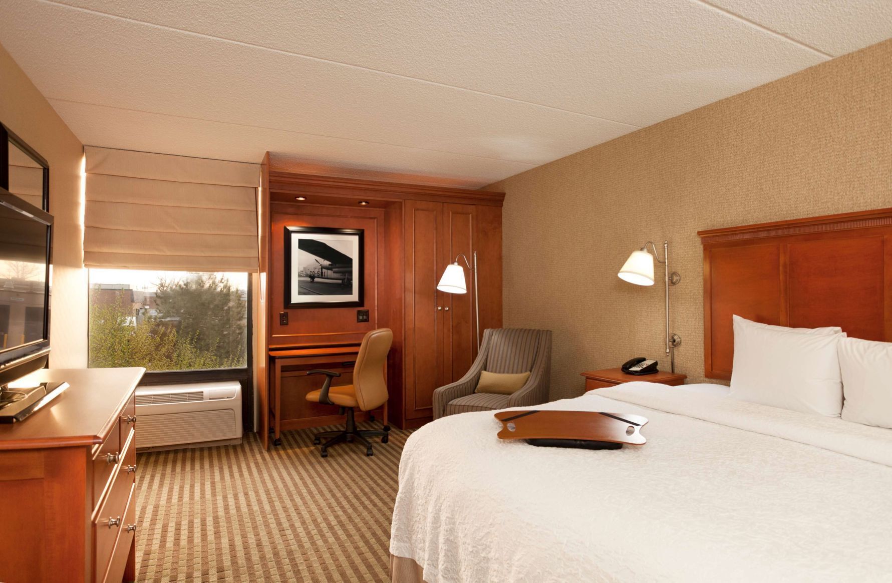 Premium bedding, desk, laptop workspace, blackout drapes