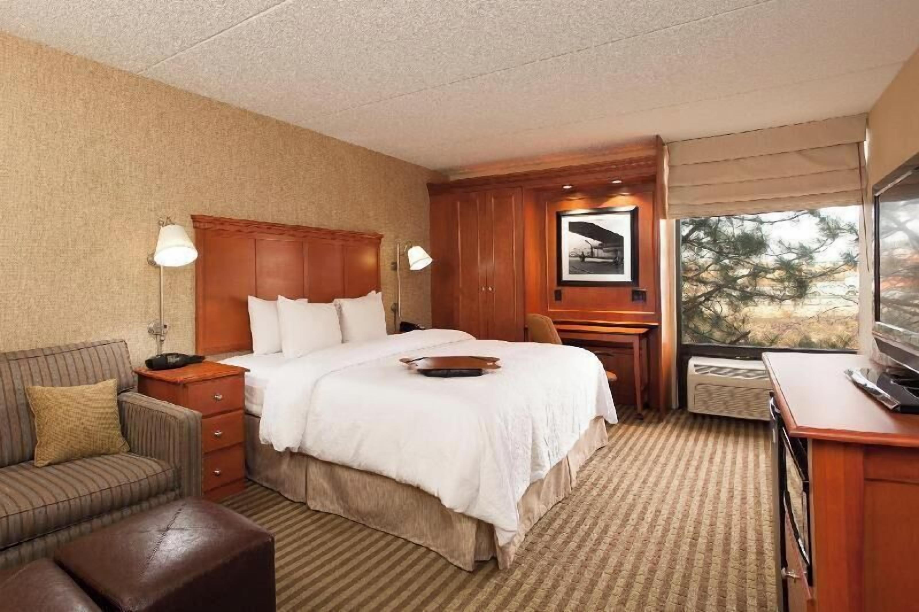 Premium bedding, desk, laptop workspace, blackout drapes